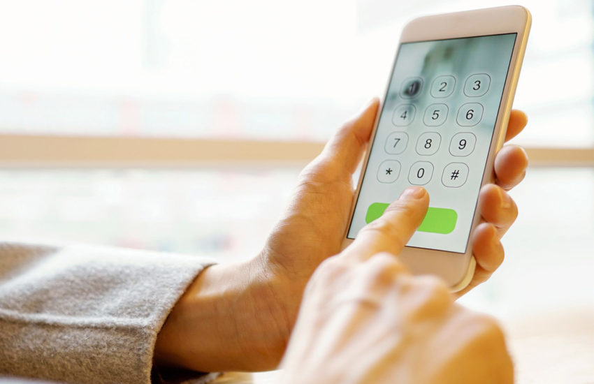 photo of female hands dialing a smartphone