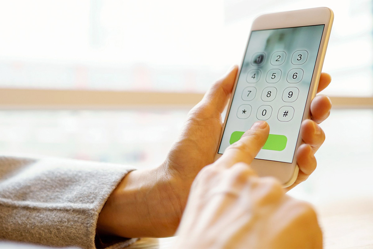 photo of female hands dialing a smartphone